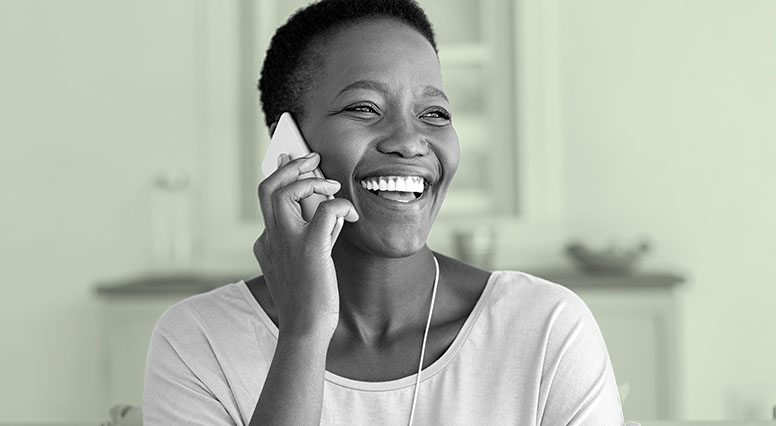 A woman smiles as she talks on the phone