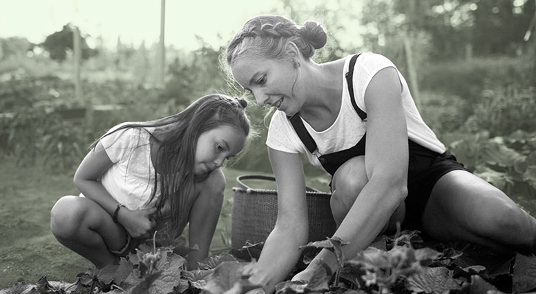 A mother and her daughter gardening
